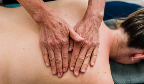 Osteopath applying pressure to Melbourne adult's back